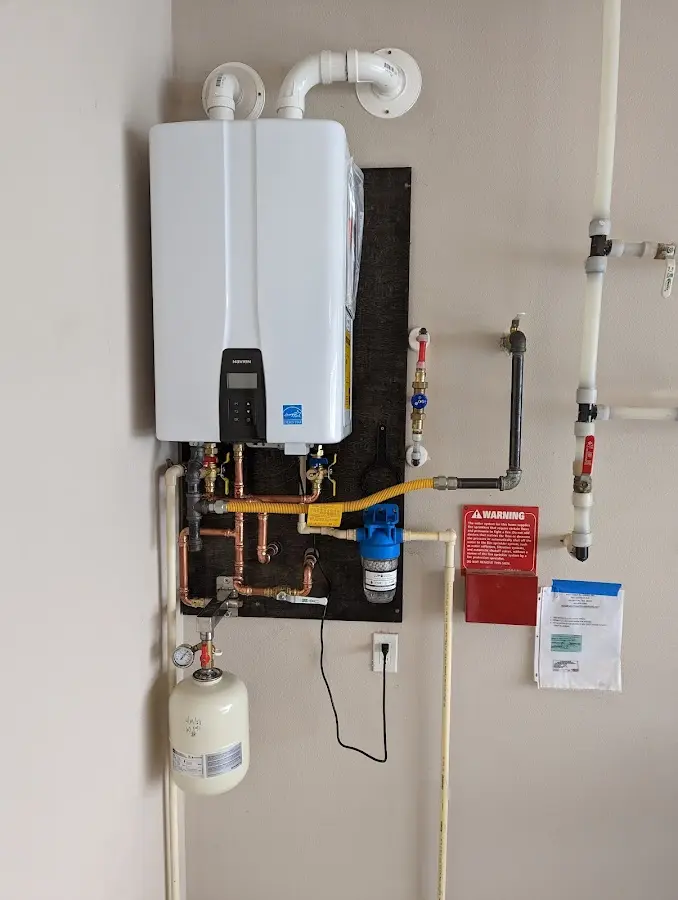 Professional plumber installing copper piping in a Fairview Heights home